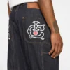 Pantaloni de tâmplar din denim cu Running Dog alergând pe marginea țesăturii